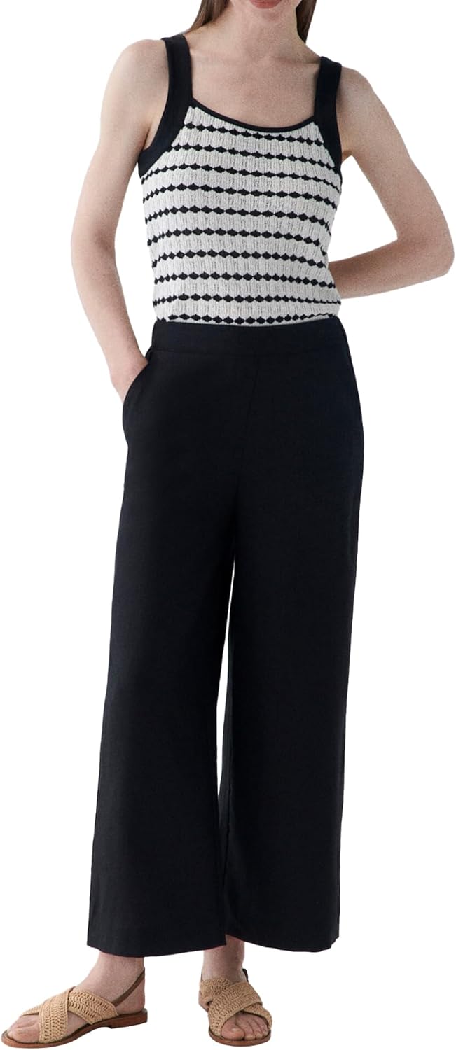 Pavo Monitor Arm mounted on a wooden desk with cables neatly managed